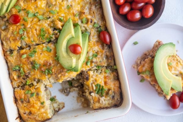 Horizontal photo of taco casserole with a slice of casserole on a plate.