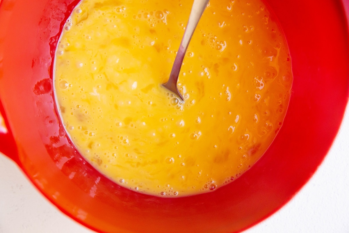 Eggs mixed up in a mixing bowl.