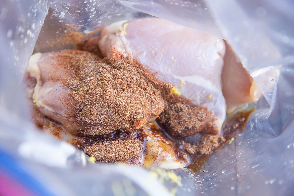 Chicken thighs, lemon juice, lemon zest, oil, and seasonings in a zip lock bag to be marinated.
