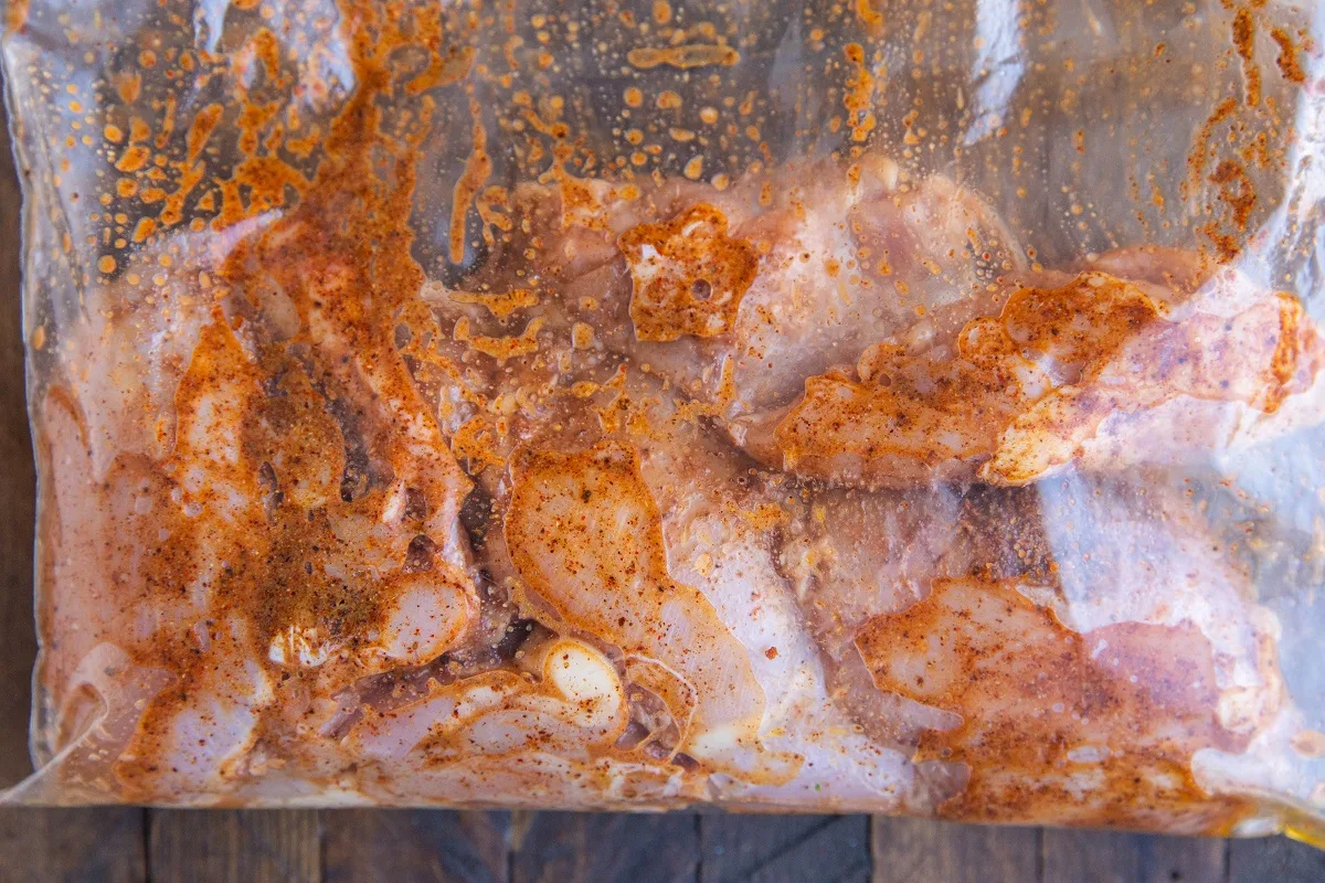 Sealed bag of marinated chicken, ready to cook.