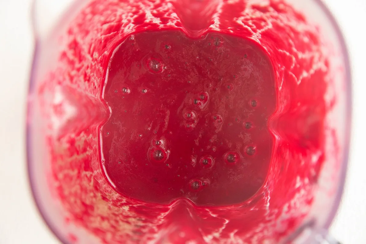 Blender with blended smoothie inside.