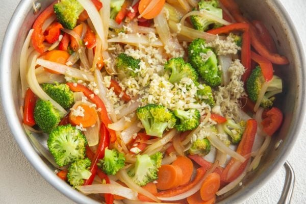 Fresh vegetables with ginger and garlic added on top to be mixed in.