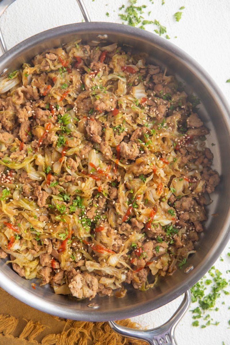Close up skillet with ground turkey and cabbage inside.
