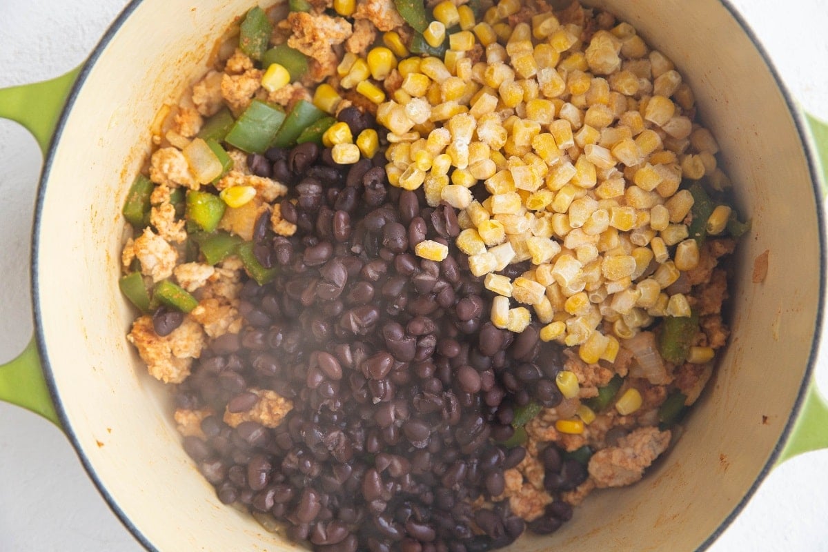 Onion, bell pepper, ground turkey, taco seasoning, black pepper, and corn in a large pot