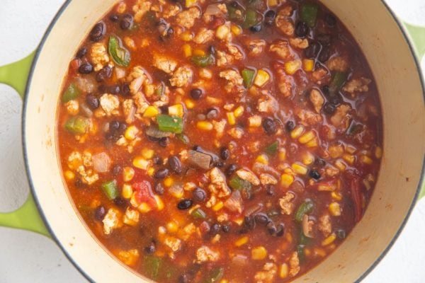 Stock pot of ground turkey taco soup, ready to cook.