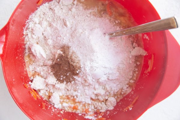 Dry ingredients on top of the wet ingredients in a mixing bowl, ready to be mixed in.