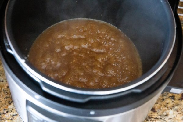 Pressure cooker with sauce boiling in it to make delicious gravy.
