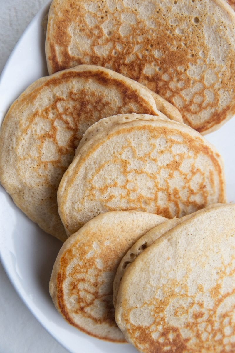 Oatmeal pancakes sitting on a plate, ready to serve.