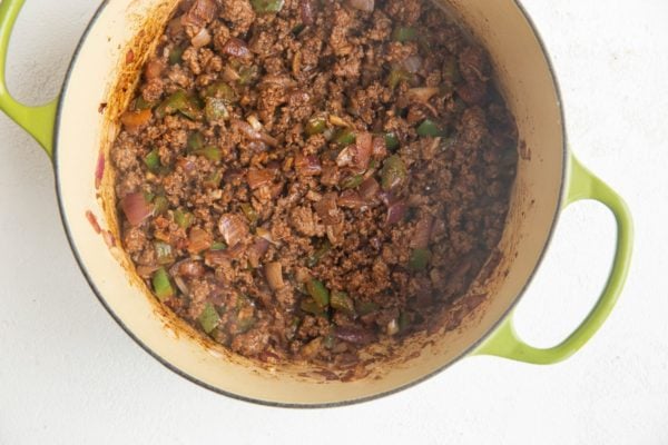Ground meat and vegetables cooking in a soup pot to make chili