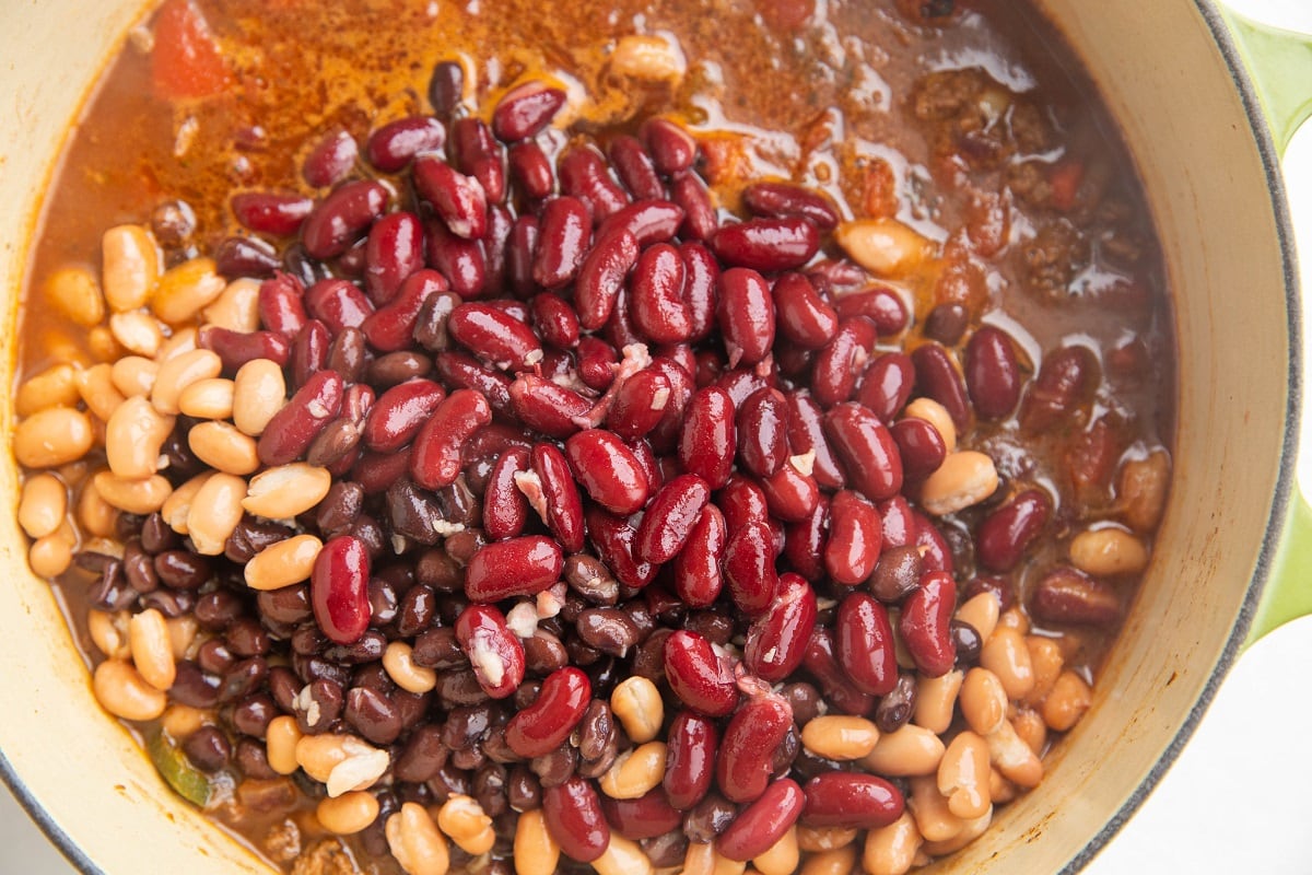 Pot of chili with beans on top, ready to be mixed in.