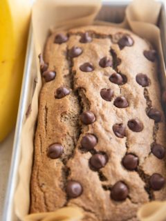 Loaf pan of vegan oatmeal banana bread, ready to be cut.