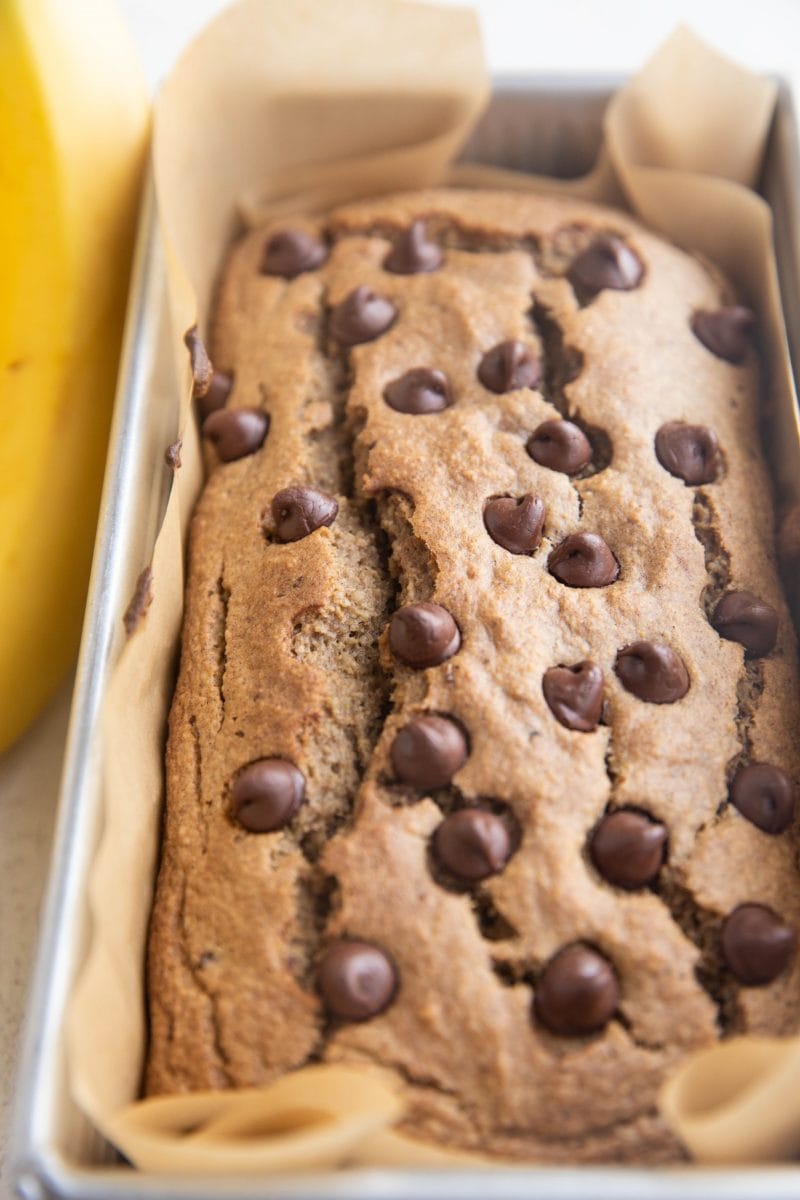 Loaf pan of vegan oatmeal banana bread, ready to be cut.