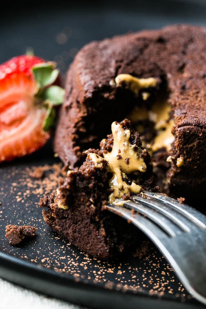 Peanut Butter Lava Cake on a plate with a fork taking a bite