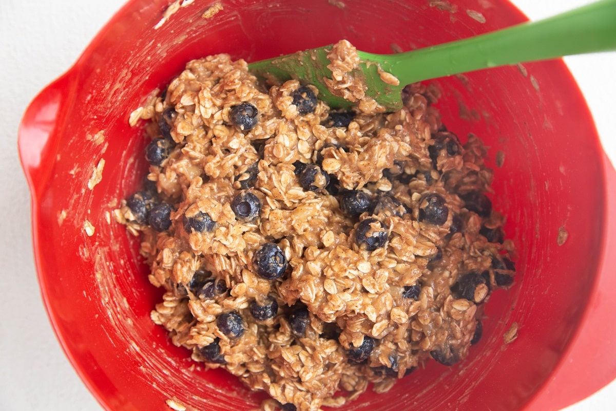 Oatmeal cookie dough in a mixing bowl, ready to be forms into cookies.