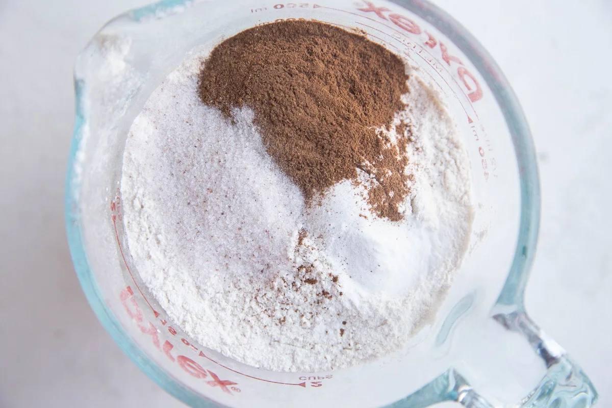 Cassava flour, cinnamon, salt, and baking powder in a bowl, ready to be stirred together.
