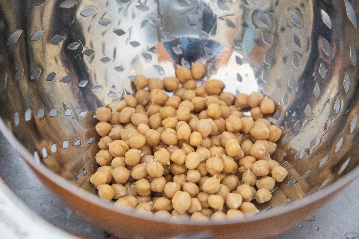Canned chickpeas draining in a colander.