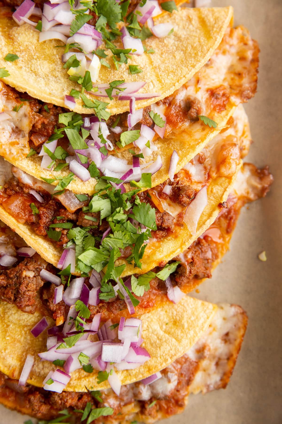 6 delicious beef tacos on a baking sheet, ready to eat.