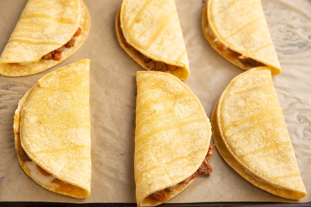 Ground beef tacos ready to go into the oven to make crispy tacos.