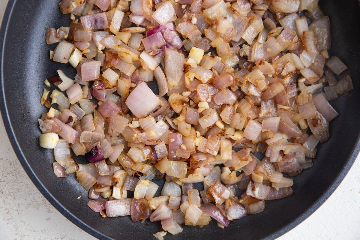 Onion and garlic cooking in a large nonstick skillet.