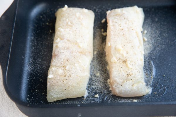 Halibut smothered in butter and sprinkled with salt, onion powder and black pepper.