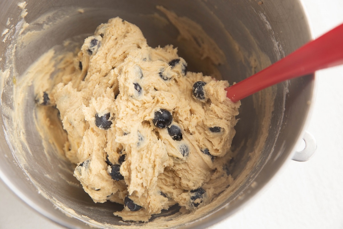 Blueberries folded into the muffin mixture to make the batter for blueberry muffin bread.