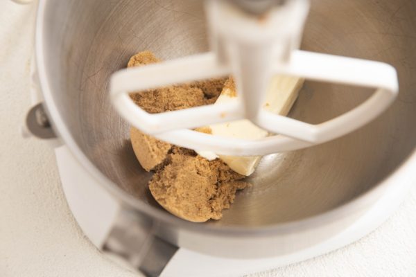 Brown sugar and butter in the bowl of a stand mixer, ready to be mixed.