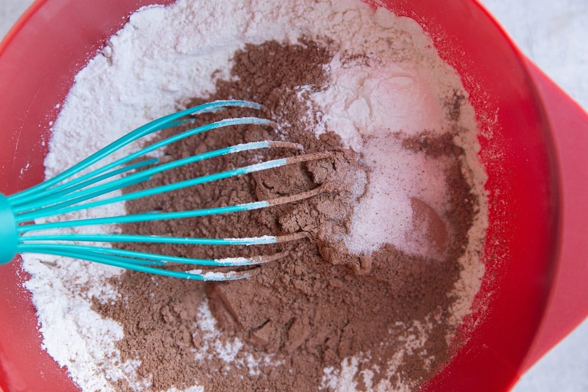 Dry ingredients for chocolate cake in a mixing bowl.