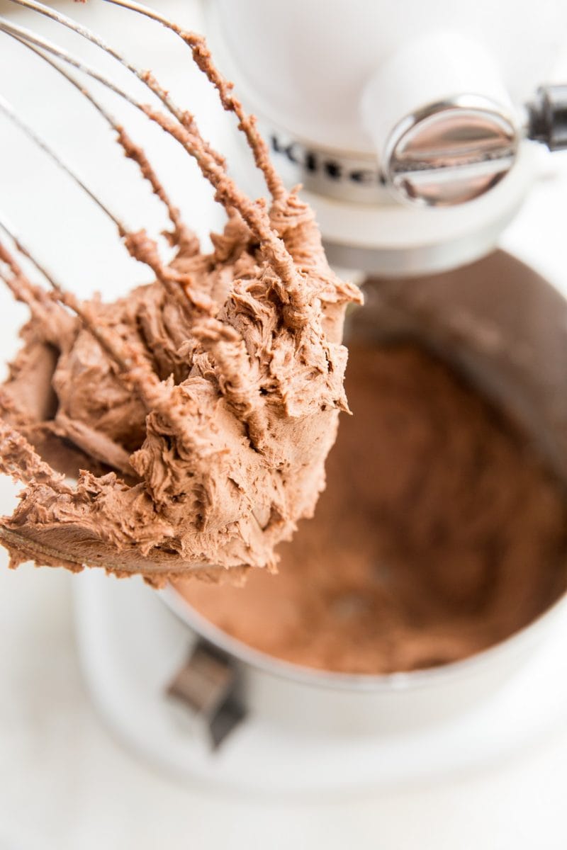 Chocolate buttercream on a whisk attachment, ready to be used.