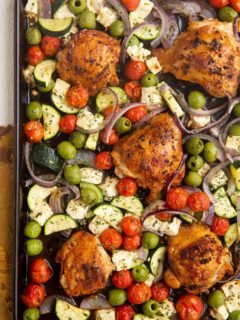 Large sheet pan with crispy chicken and vegetables, ready to be served.