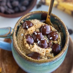 Mug cake with a spoon inside, ready to eat.