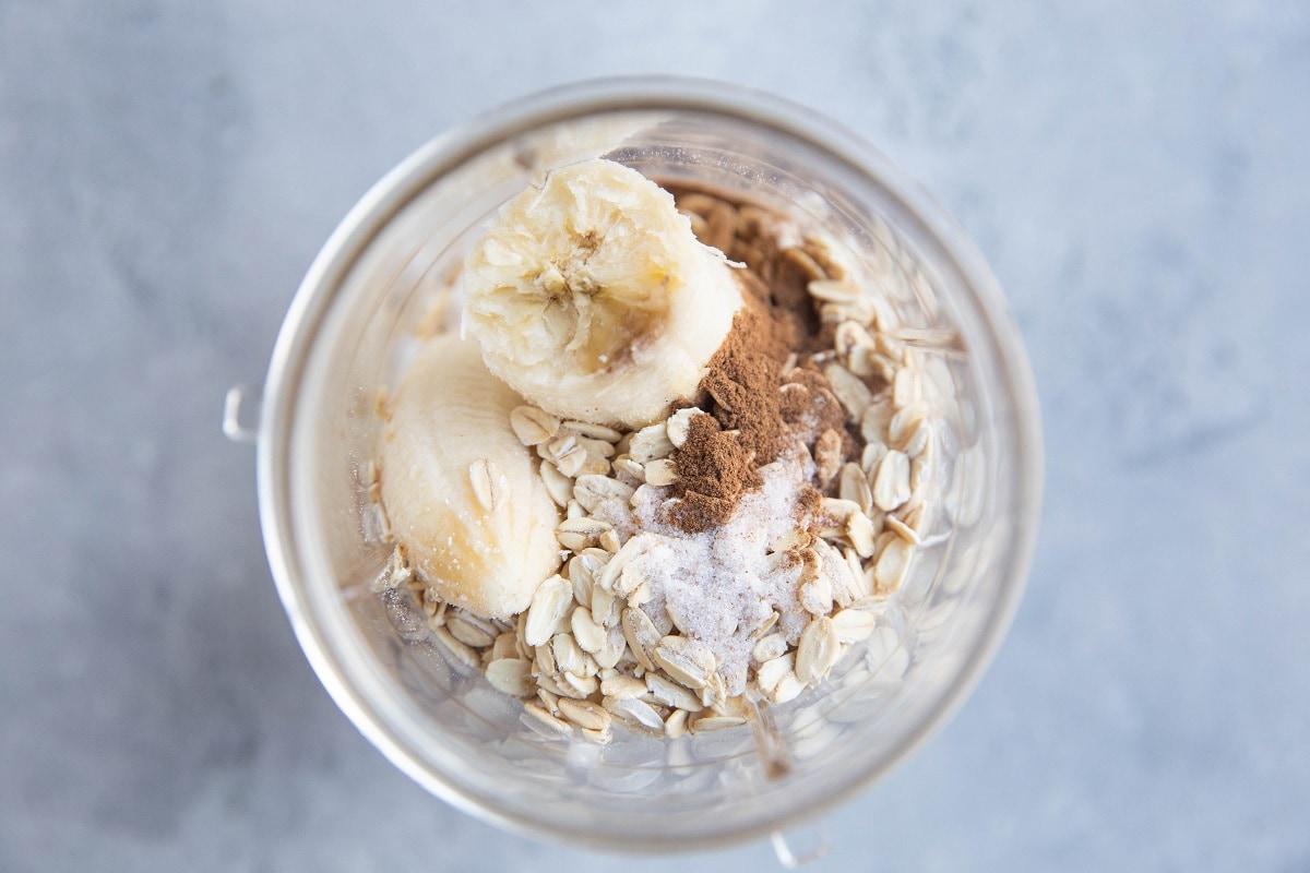 Ingredients for banana bread mug cake in a Magic Bullet blender, ready to be blended.