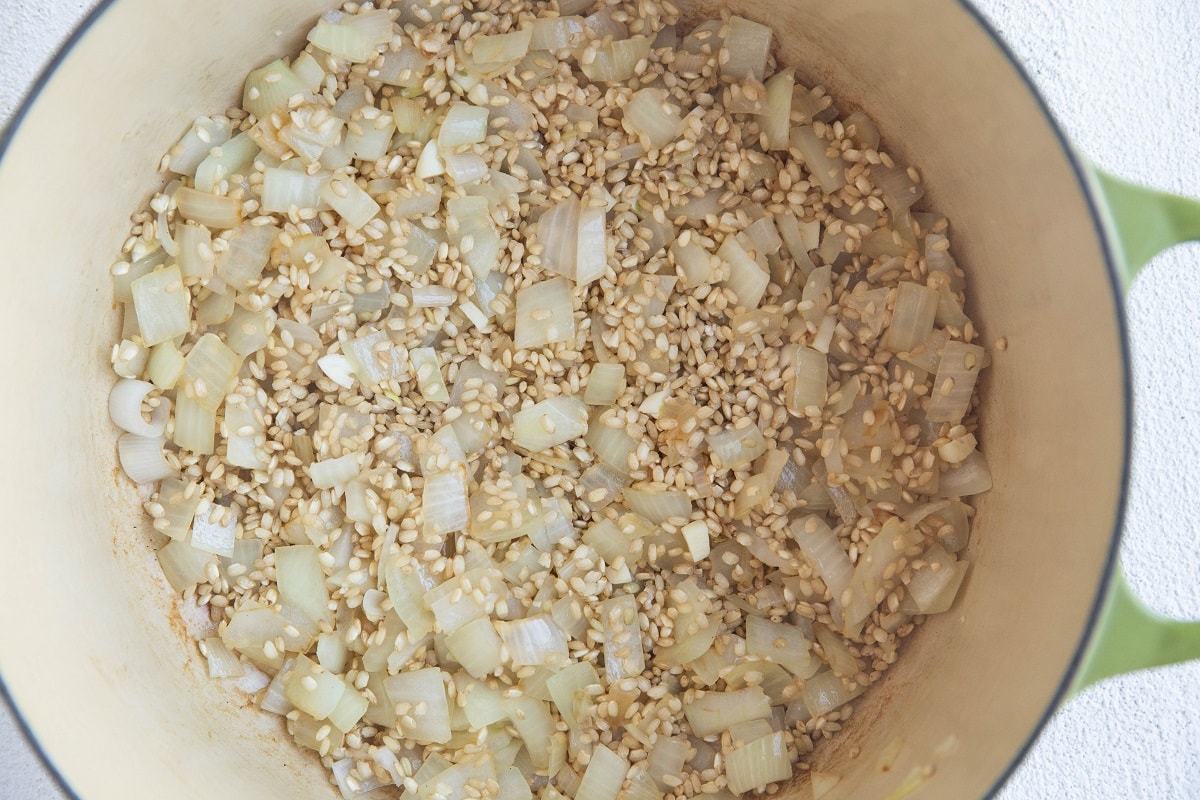 Rice, onion and garlic cooking in a stock pot.