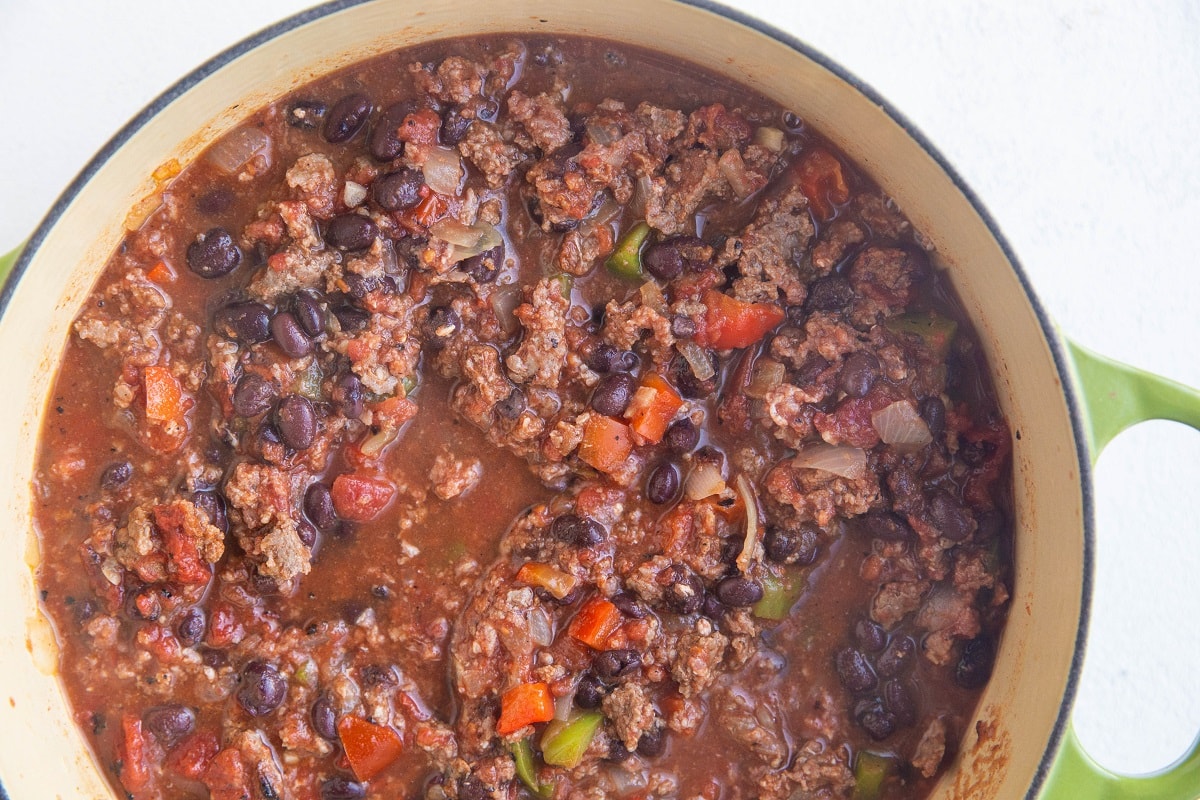 Large pot of beef chili, ready to cook at a boil.