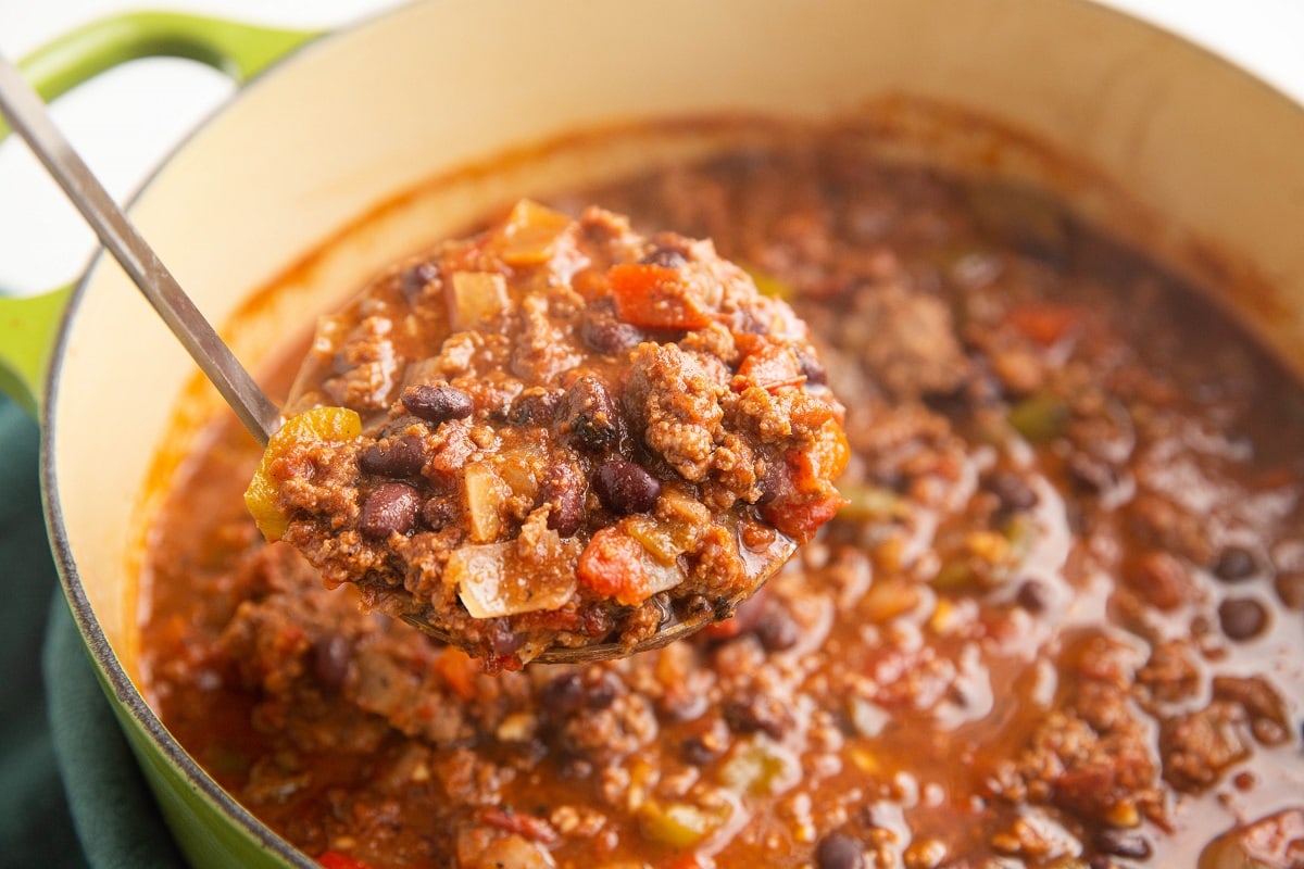 Ladle scooping chili out of a pot to serve.