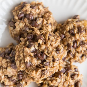 3-Ingredient Oatmeal Cookies with chocolate chips on a white plate, ready to eat, fresh out of the oven.