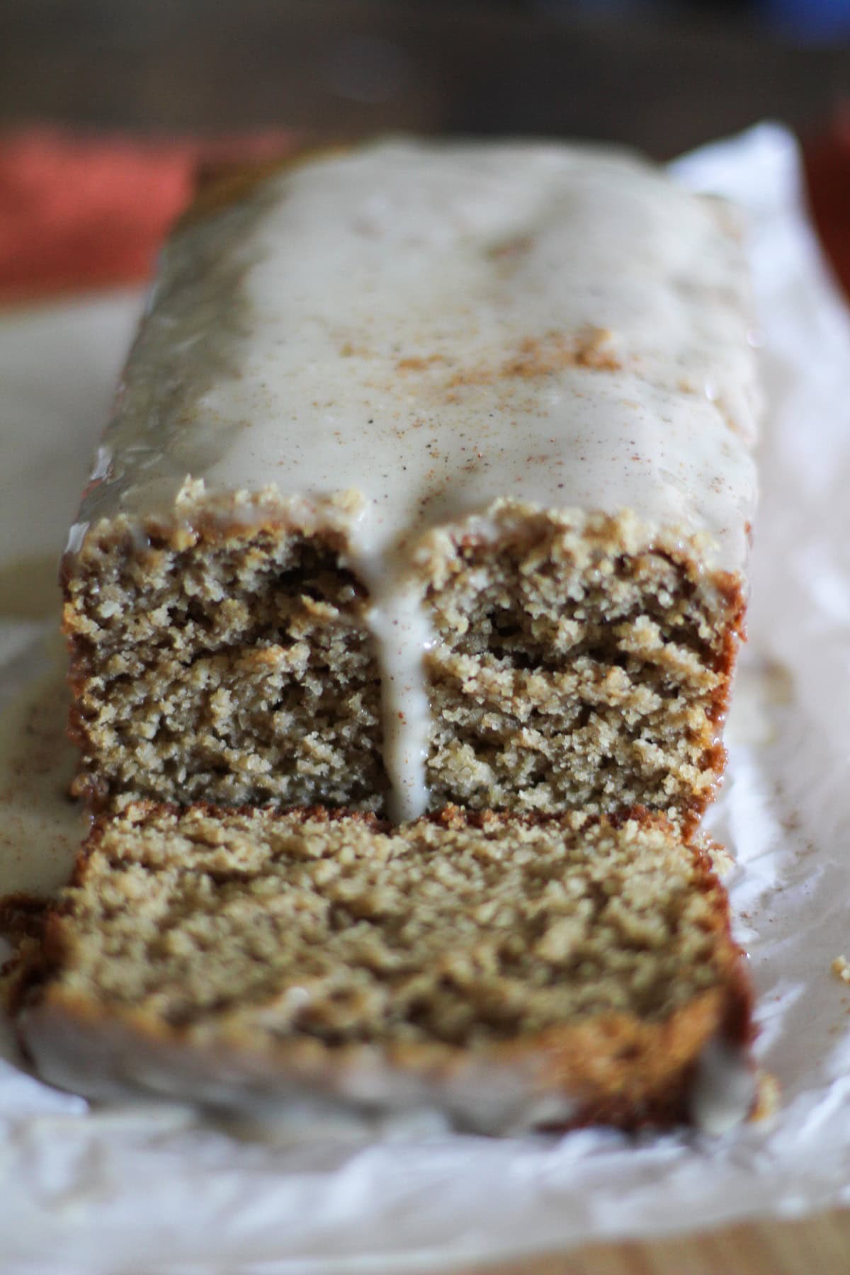Loaf of eggnog bread with a slice taken out.