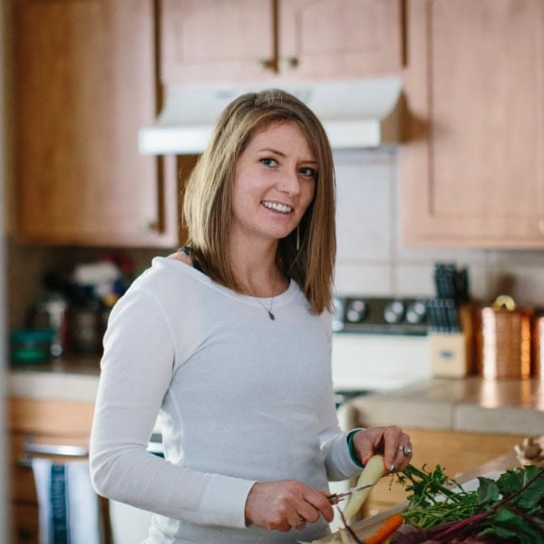 Julia Mueller peeling carrots in a kitchen