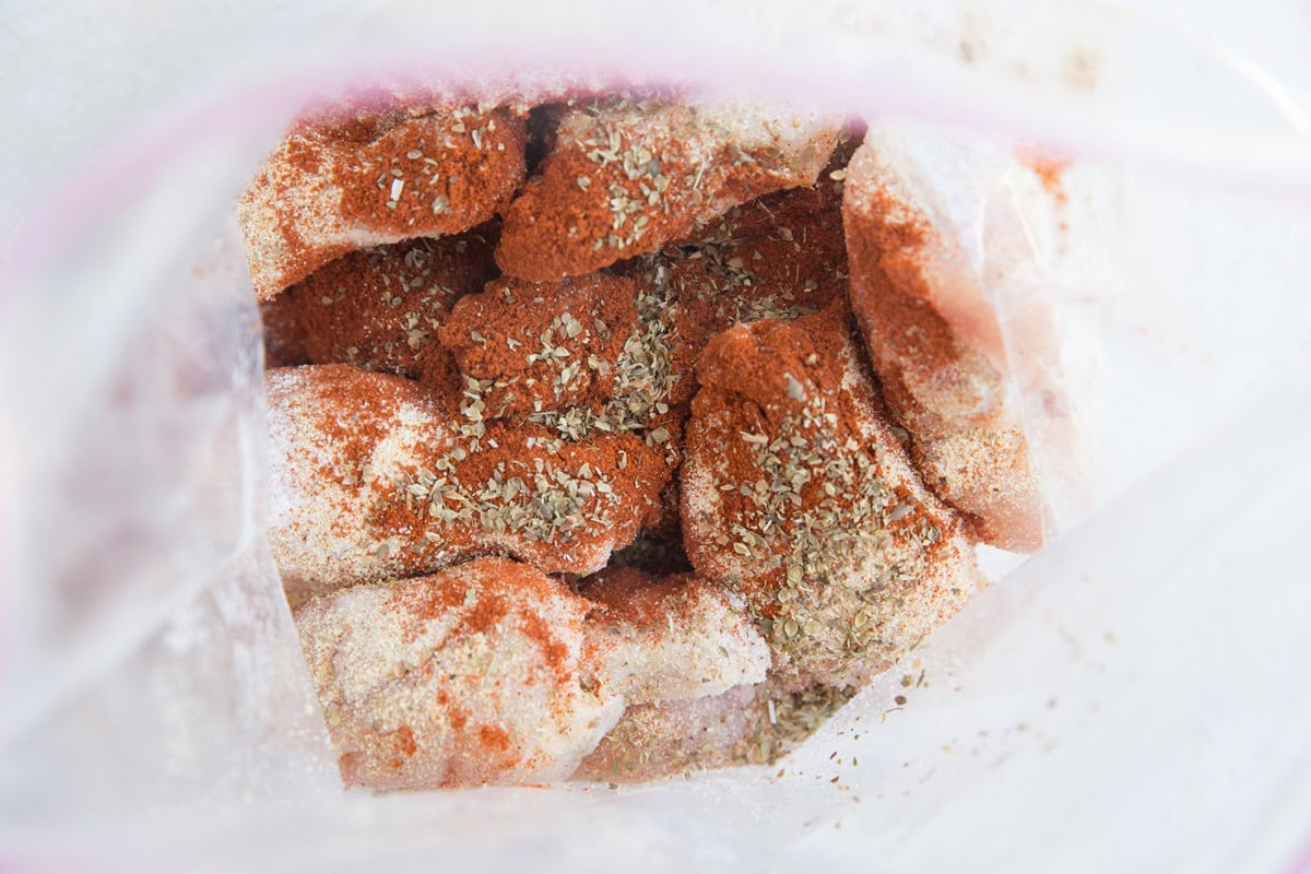 chicken wings and seasonings in a zip lock bag