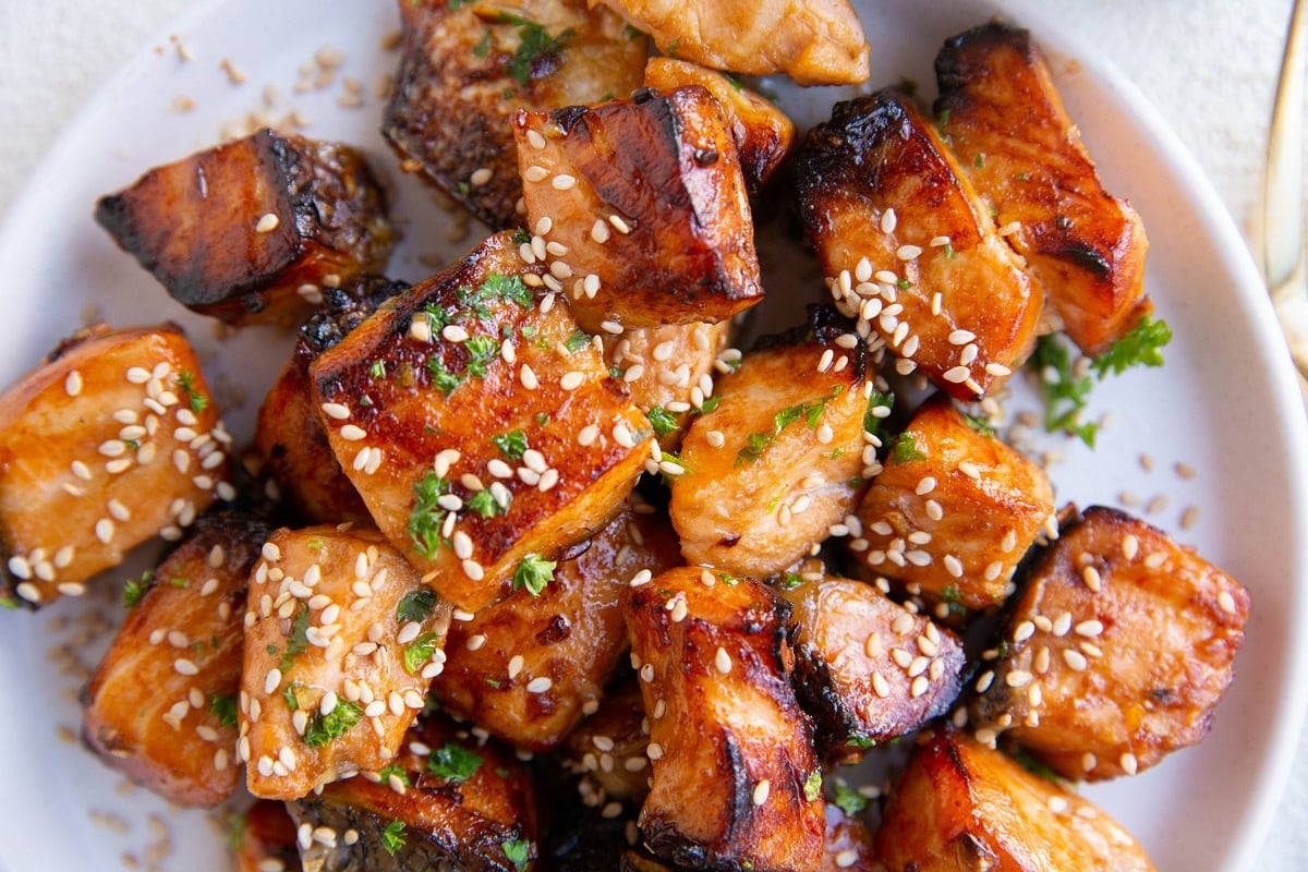 White plate of crispy air fryer salmon bites, ready to serve.