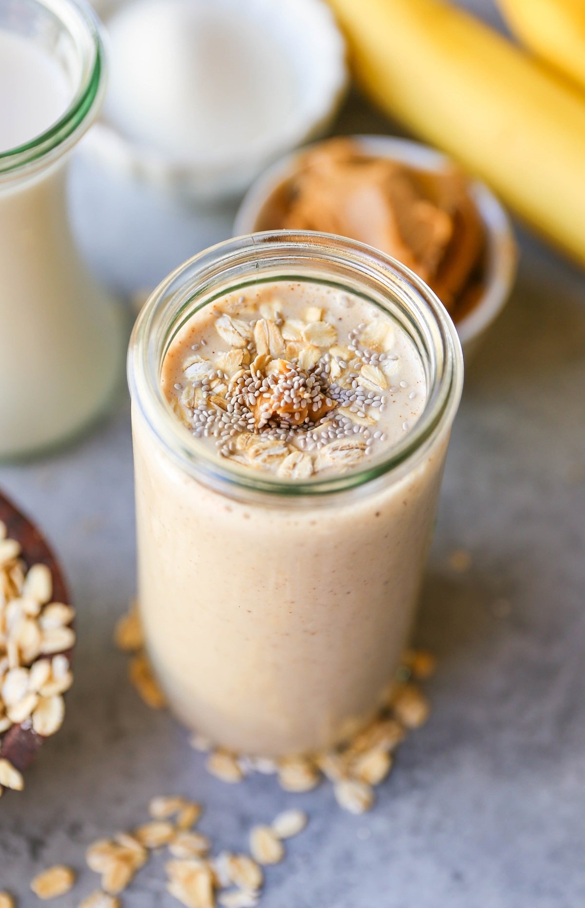 Almond Butter Protein Smoothie with chia seeds, banana, and oats in a glass, ready to drink