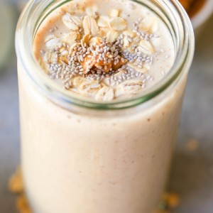 Almond Butter Protein Smoothie with chia seeds, banana, and oats in a glass, ready to drink