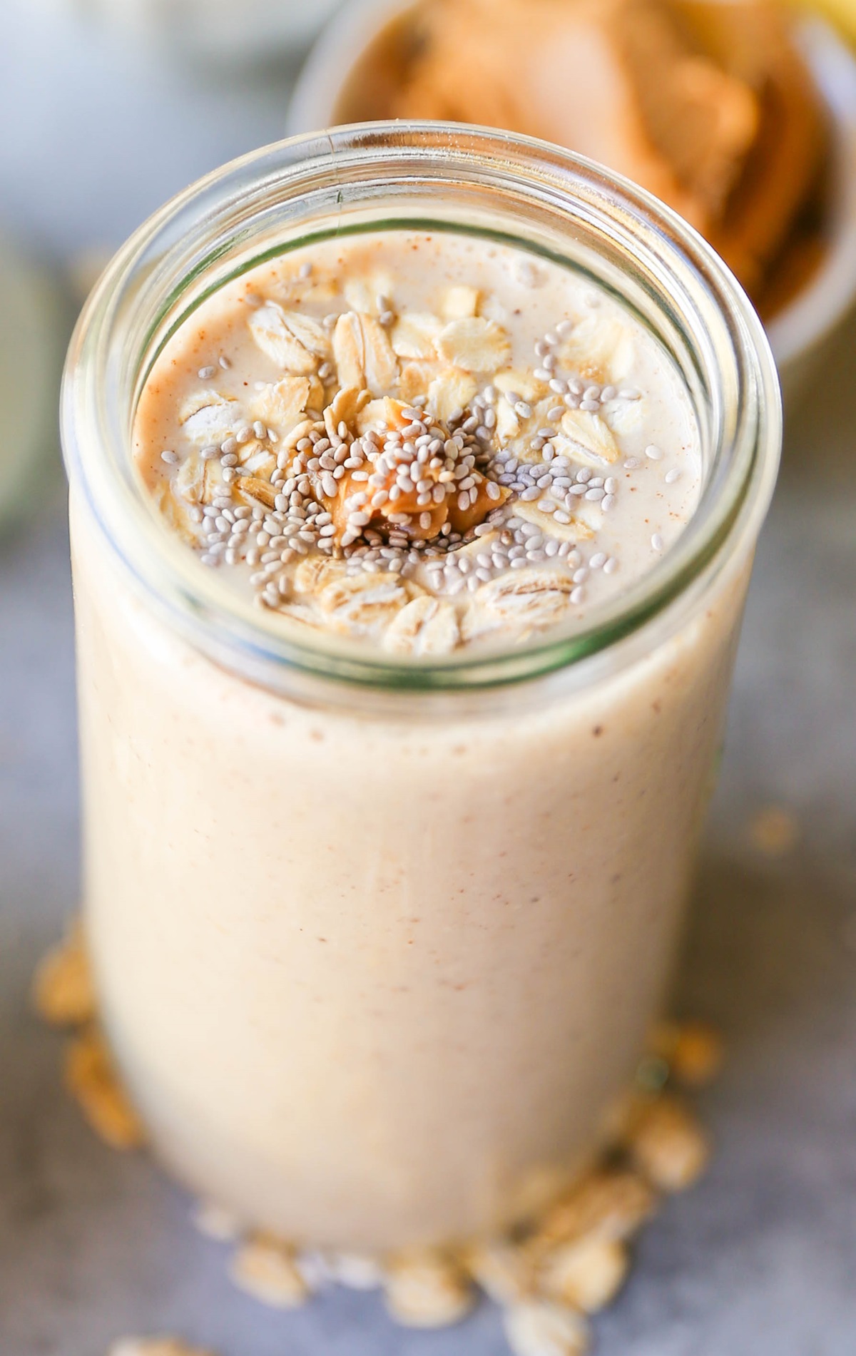 Almond Butter Protein Smoothie with chia seeds, banana, and oats in a glass, ready to drink