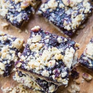 Blueberry crumb bars stacked on top of each other.