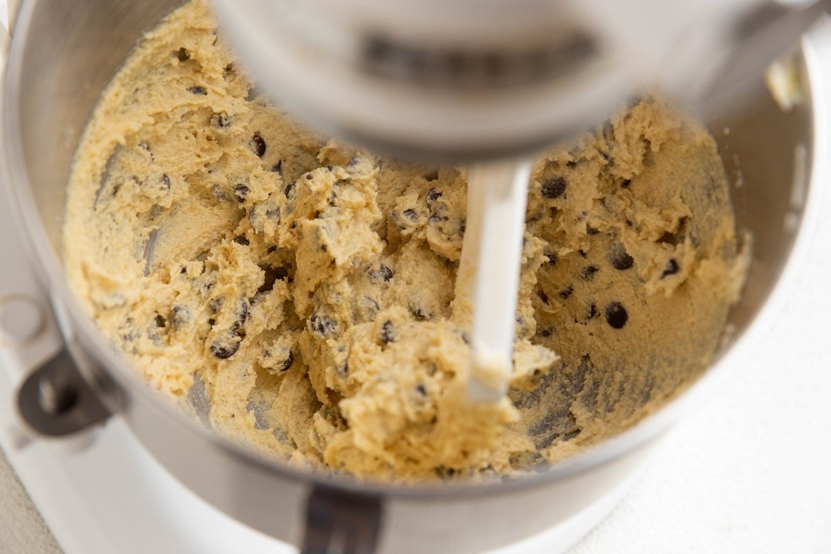 Almond flour cookie bar dough in a stand mixer, ready to be made into bars.