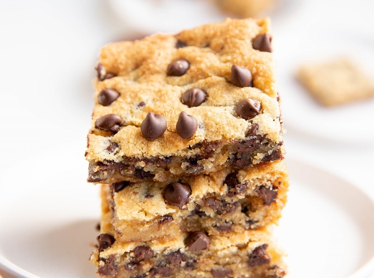 Three cookie bars sitting on a plate, ready to eat.