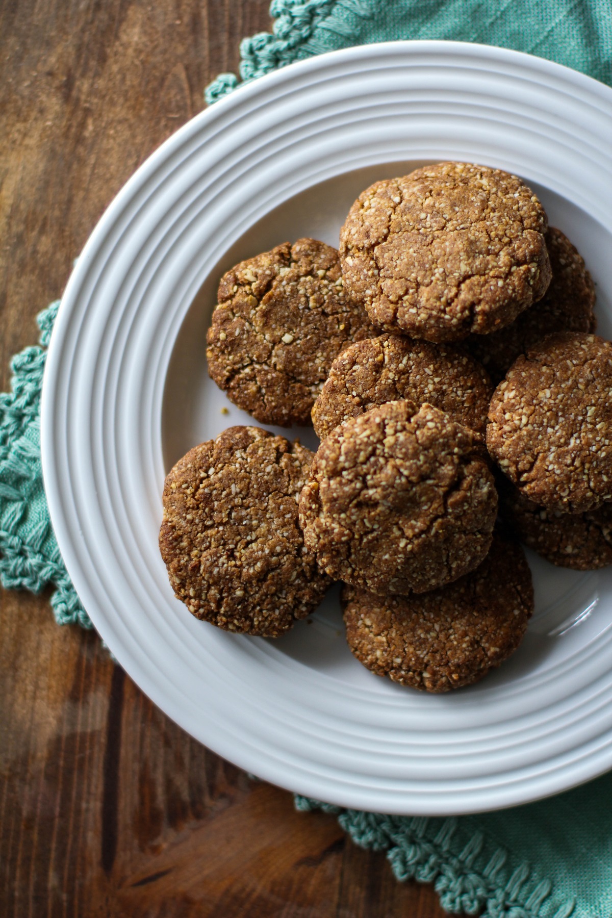 Gingerbread cookies on a white plate with a teal napkin.