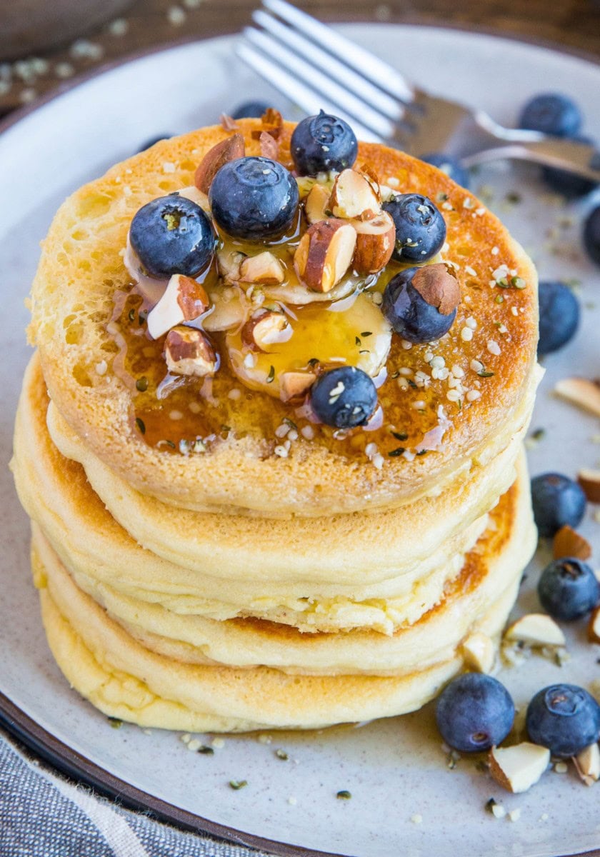 Almond flour pancakes on a plate with blueberries and banana, ready to eat