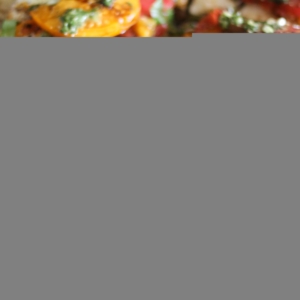 Caprese Pizza Recipe on top of almond flour pizza crust with chimichurri sauce drizzled on top.