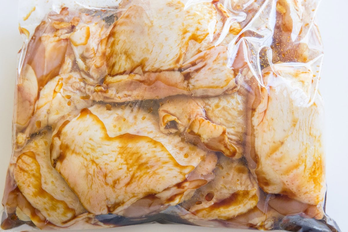 Marinated chicken in a large zip lock bag.