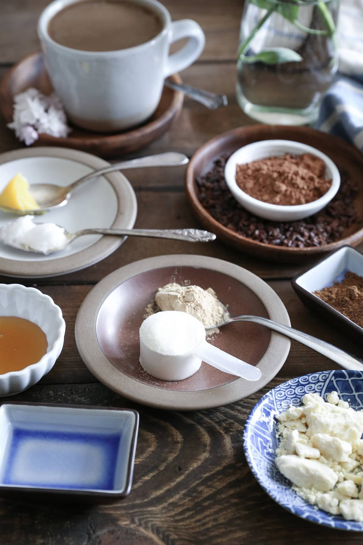 Ingredients for Bulletproof Coffee on a wooden table, with additions available.